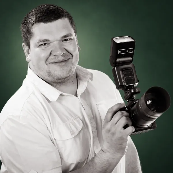 Pavel holding his camera and flash